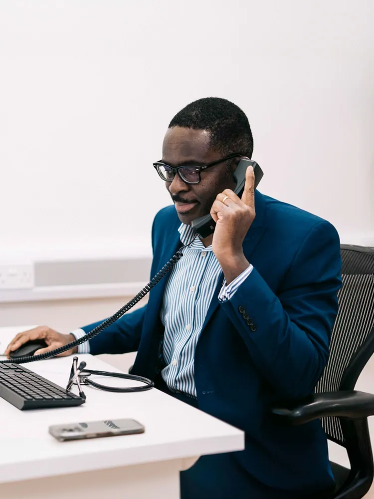 Doctor Ike Nnene on the phone with a client discussing the next steps of a home detox