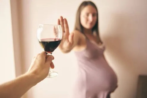 Pregnant woman saying no to red wine, she knows it can be a cause of Foetal Alcohol Spectrum Disorder (FASD)