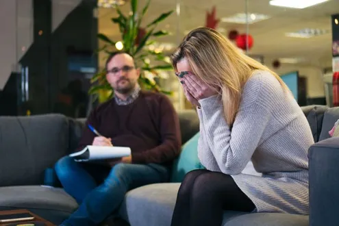 Rehabs UK Senior Treatment Advisor Scott Ardley supports a client with feedback on their recovery within group therapy