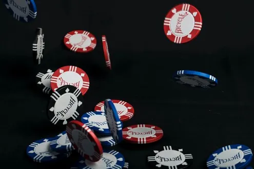 Gambling chips fall onto a table representing gambling addiction