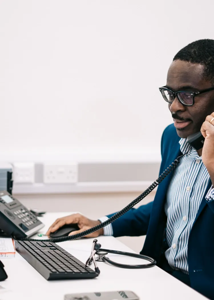 Doctor Ike Nnene on the phone with a client discussing the next steps of a home detox