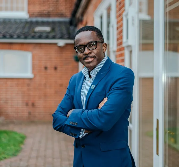 Dr Ike Nnene is stood outside his surgery welcoming a client for an assessment for a home detox for substance addiction