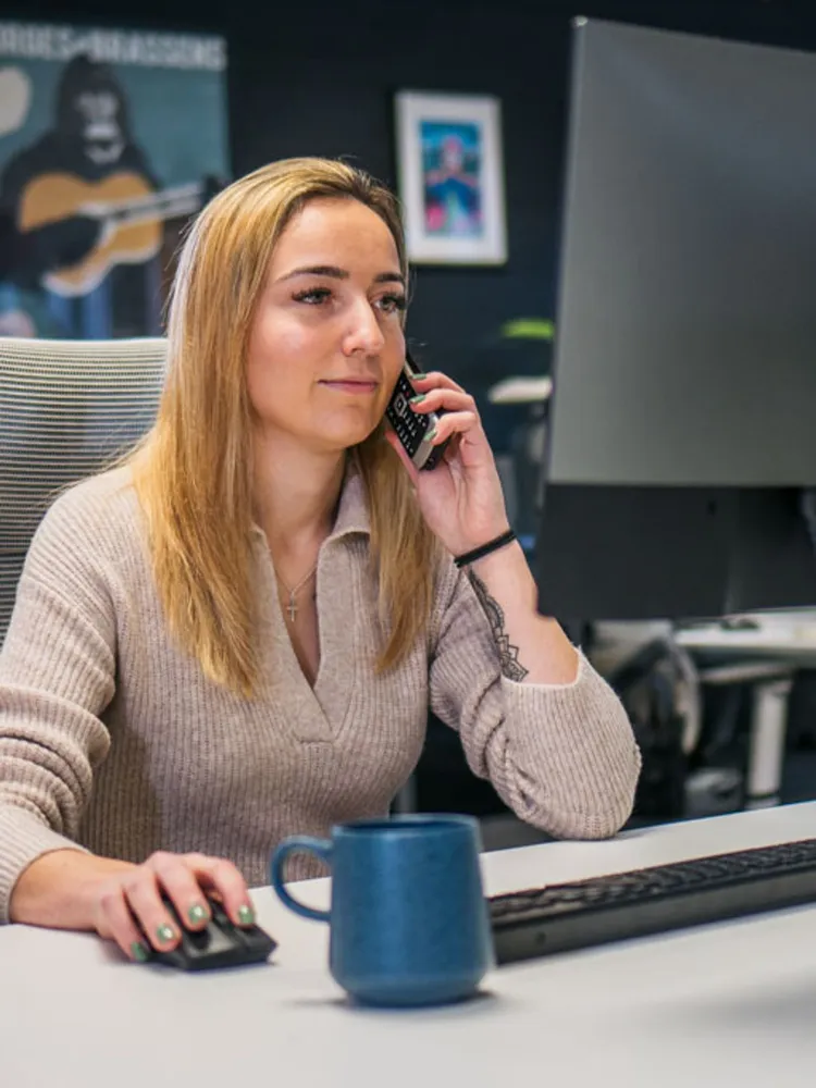 Treatment Advisor Hannah Levi on a call in the office