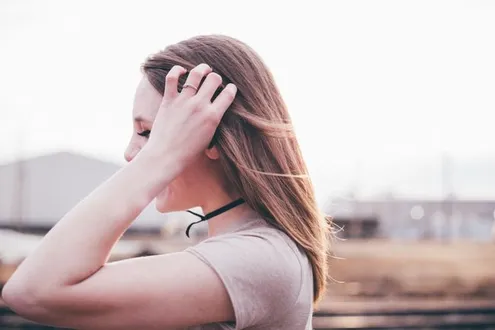 A woman runs her hand through her hair she has taken Nitazenes which are super strength drugs